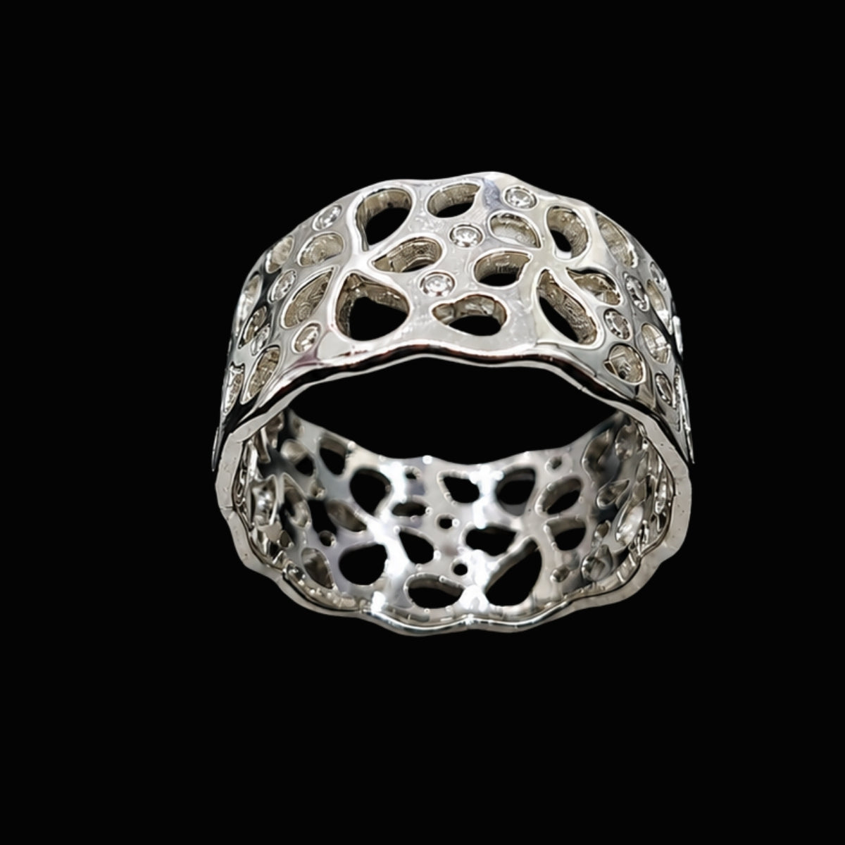 A silver ring with intricate cut-out details and sparkling CZ stones.