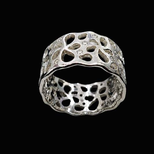 A silver ring with intricate cut-out details and sparkling CZ stones.