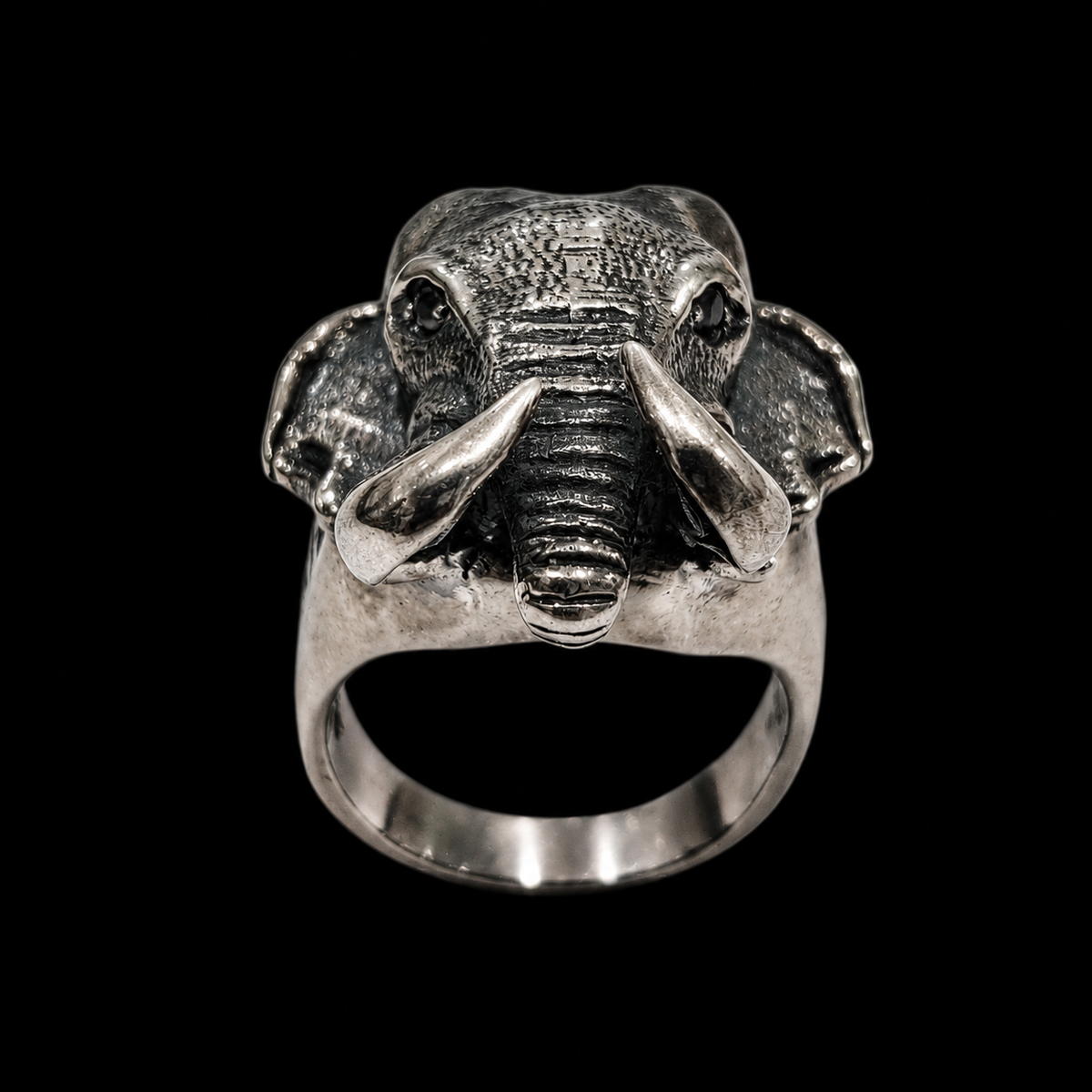 A silver ring featuring an elephant design with CZ stones.