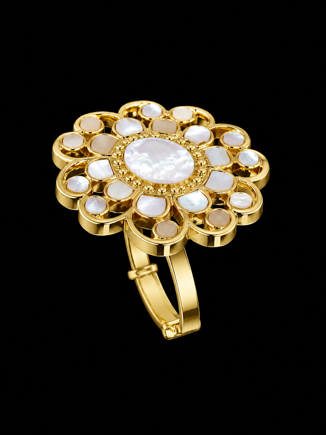 A gold ring with a flower motif and mother of pearl stones.