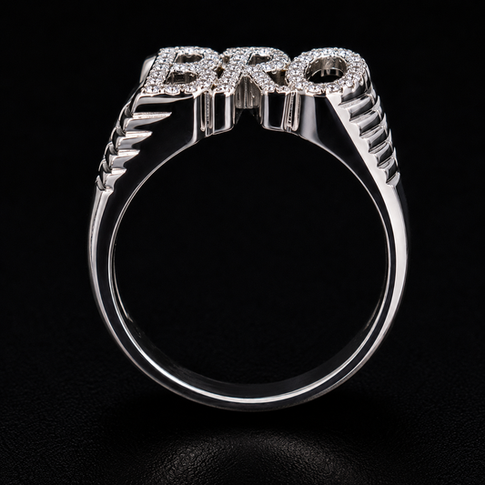 A silver ring with the word "PRO" in block letters, set with clear cubic zirconia stones.