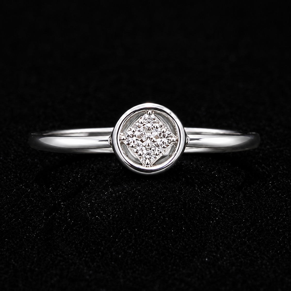 A silver ring with a round CZ stone in a circular setting.