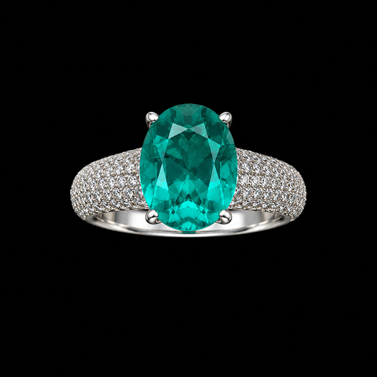 A silver ring with an oval-cut emerald gemstone.