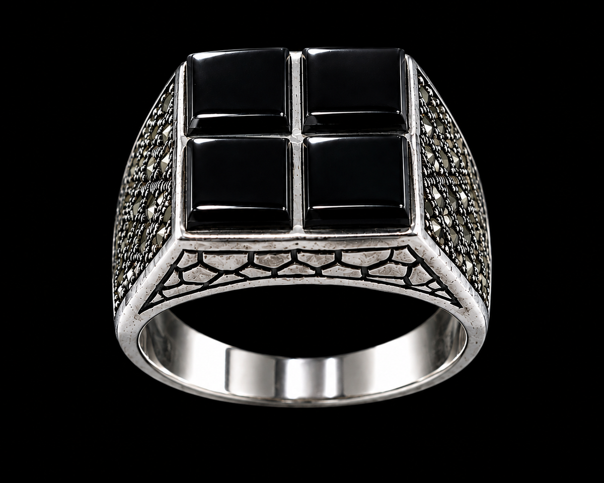 A silver-tone ring with a black cross design and black CZ stones.