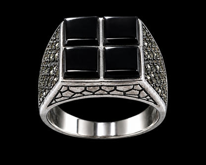 A silver-tone ring with a black cross design and black CZ stones.
