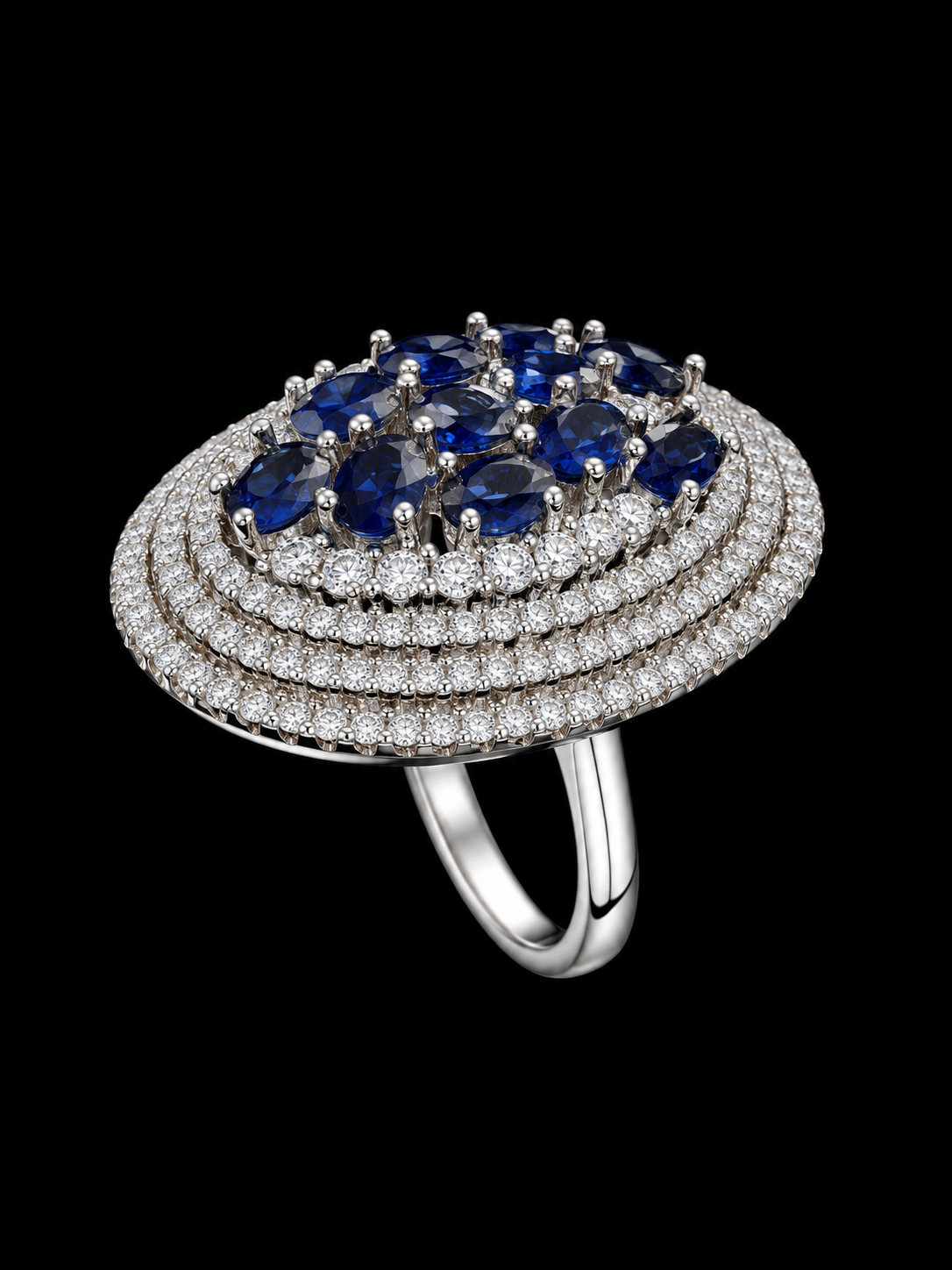 A silver-tone ring with a blue CZ stone and clear CZ halo