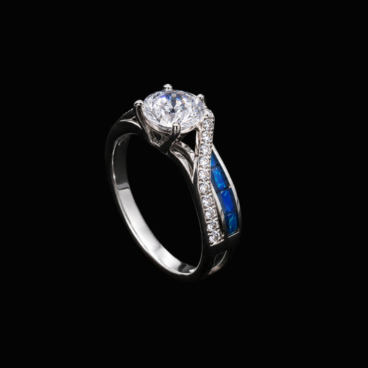 A silver ring with a large round-cut CZ stone and blue enamel accents.