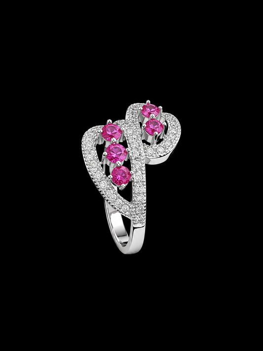 A silver ring with a heart-shaped design and pink CZ stones.