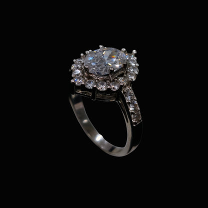A silver ring with a floral design and clear CZ stones.