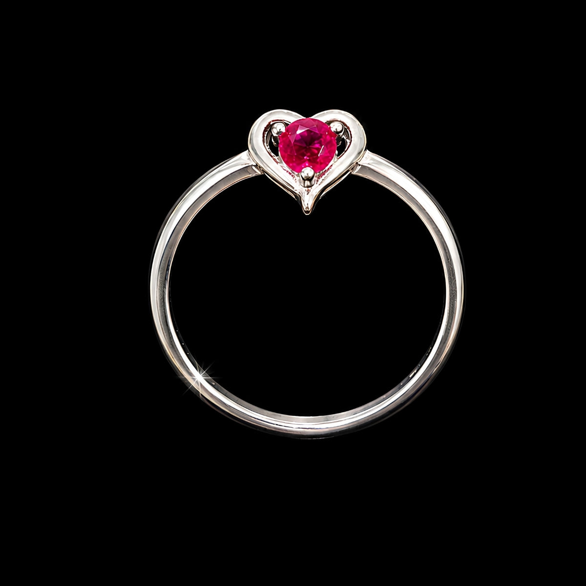 A silver ring with a heart-shaped design and a pink CZ stone at its center.