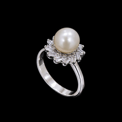 A pearl ring with CZ stones on a silver band.