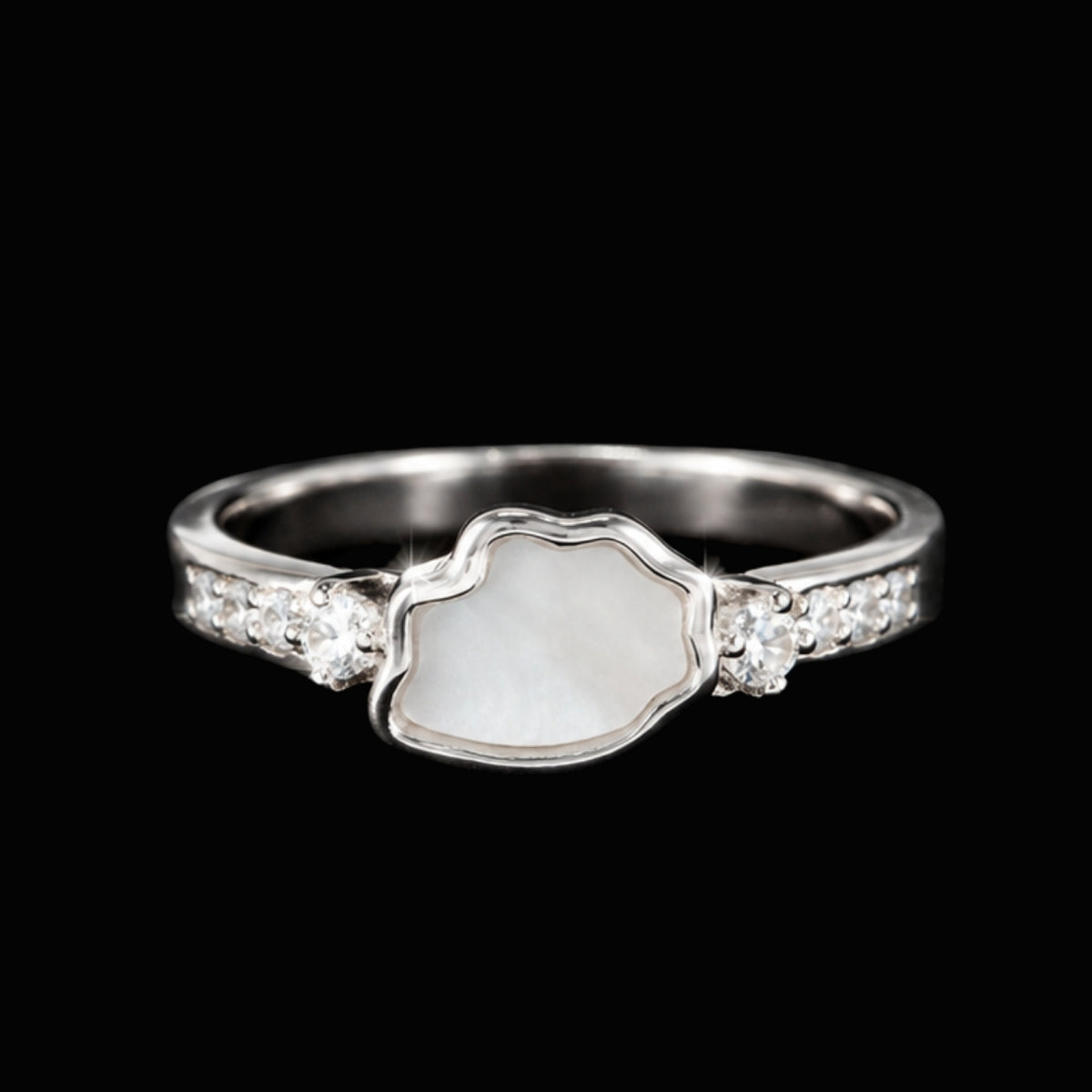 A silver ring with a wavy edge design and white CZ stones