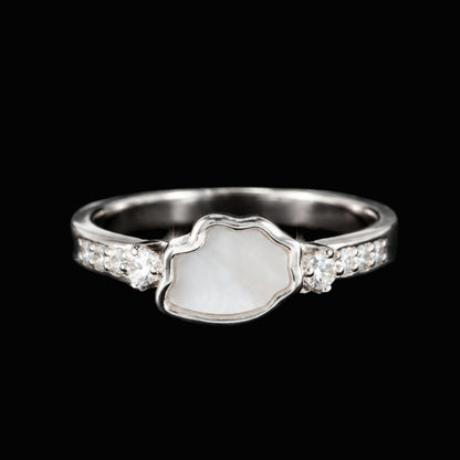 A silver ring with a wavy edge design and white CZ stones