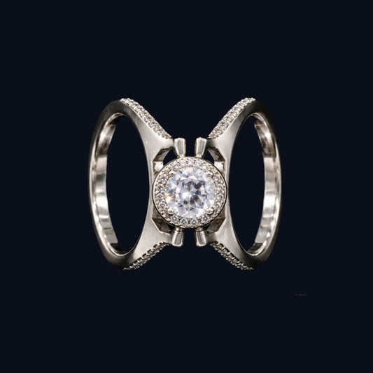 A silver-tone ring with a round-cut CZ stone surrounded by smaller CZ stones, set in a crisscross design.