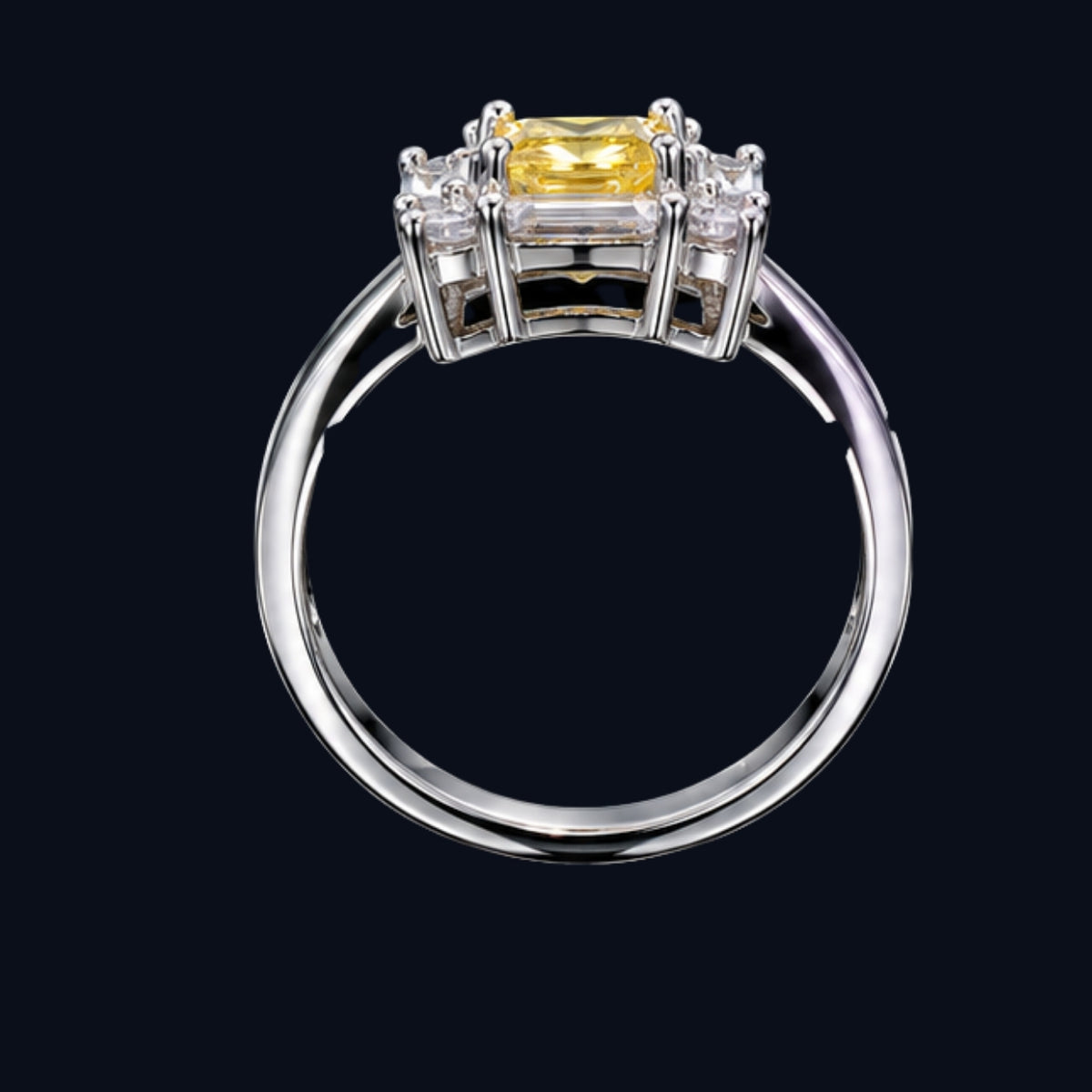 A silver ring with a yellow CZ stone, set in a classic design.