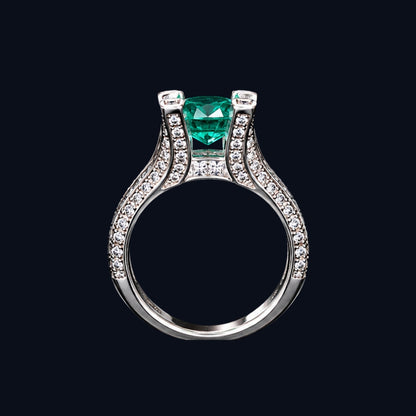 A silver ring with an emerald stone and CZ stones