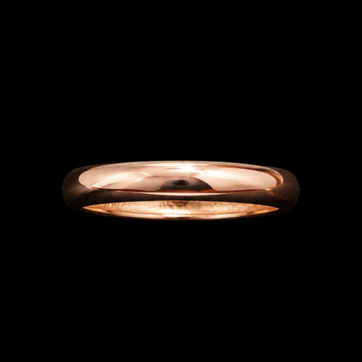 A gold tone ring with a smooth, rounded design.