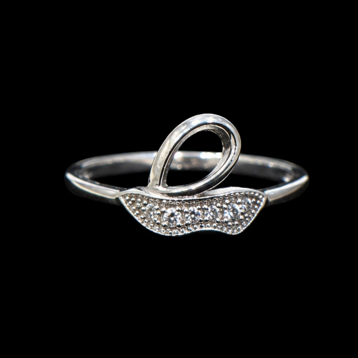 A silver ring with a wavy design and CZ stones.