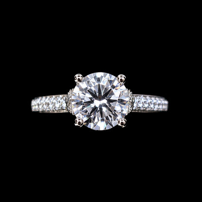 A silver ring with a large round-cut CZ stone and smaller stones on the band.