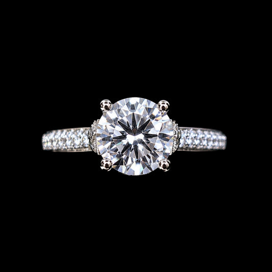 A silver ring with a large round-cut CZ stone and smaller stones on the band.