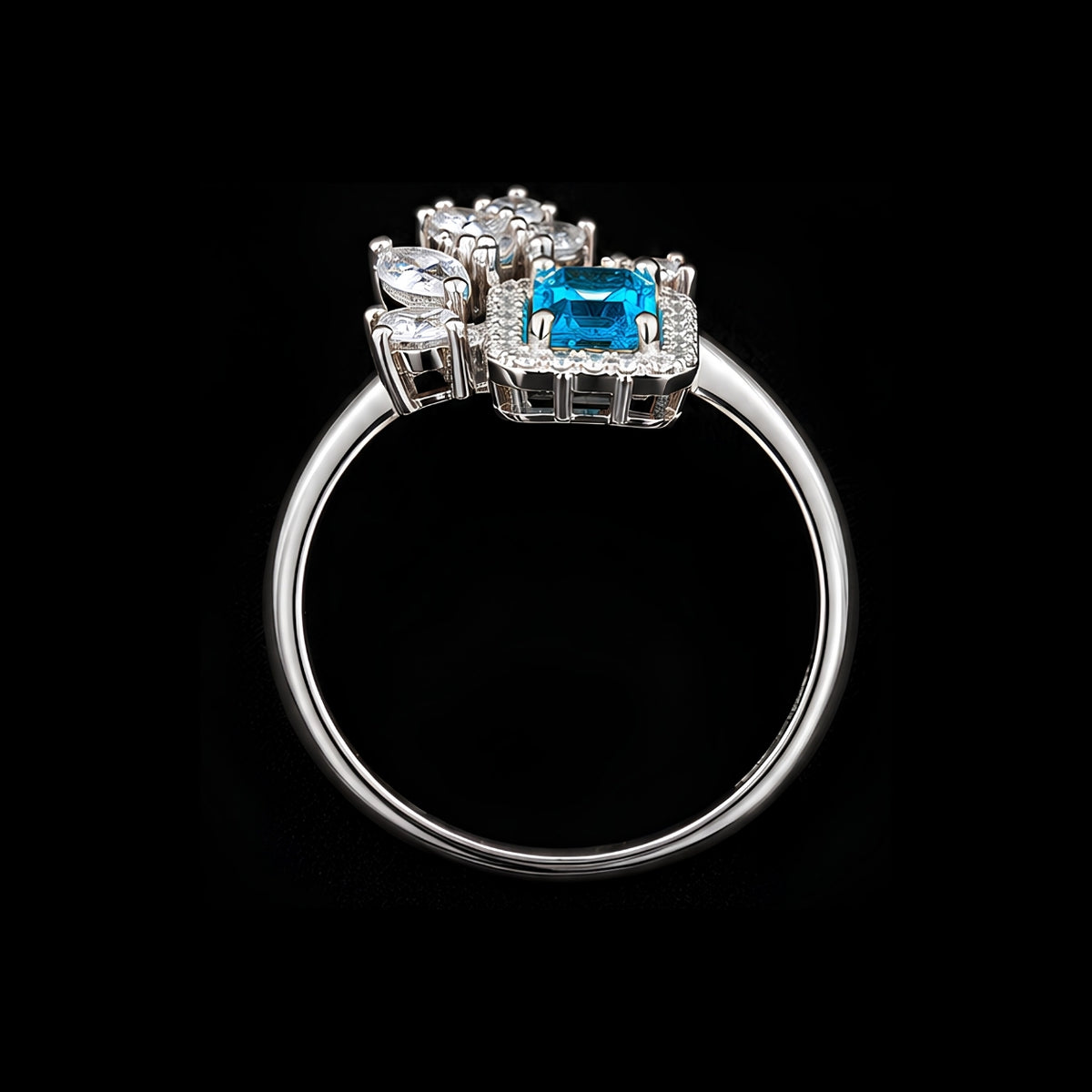 A silver-tone ring with a blue CZ stone and clear CZ accents.