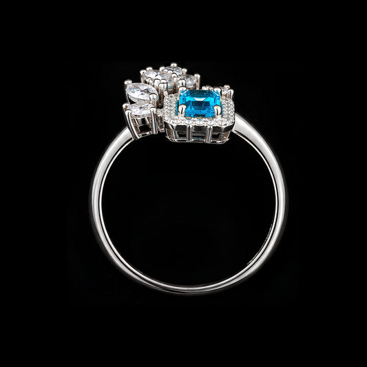A silver-tone ring with a blue CZ stone and clear CZ accents.