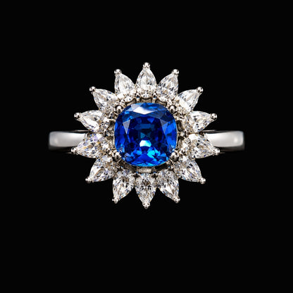 A silver ring with a blue sapphire and clear CZ stones