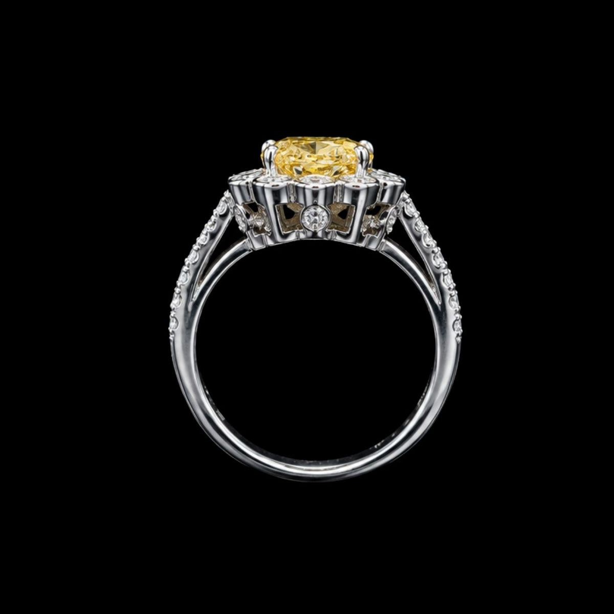 A silver-tone ring with a large yellow CZ stone, set in a modern design.