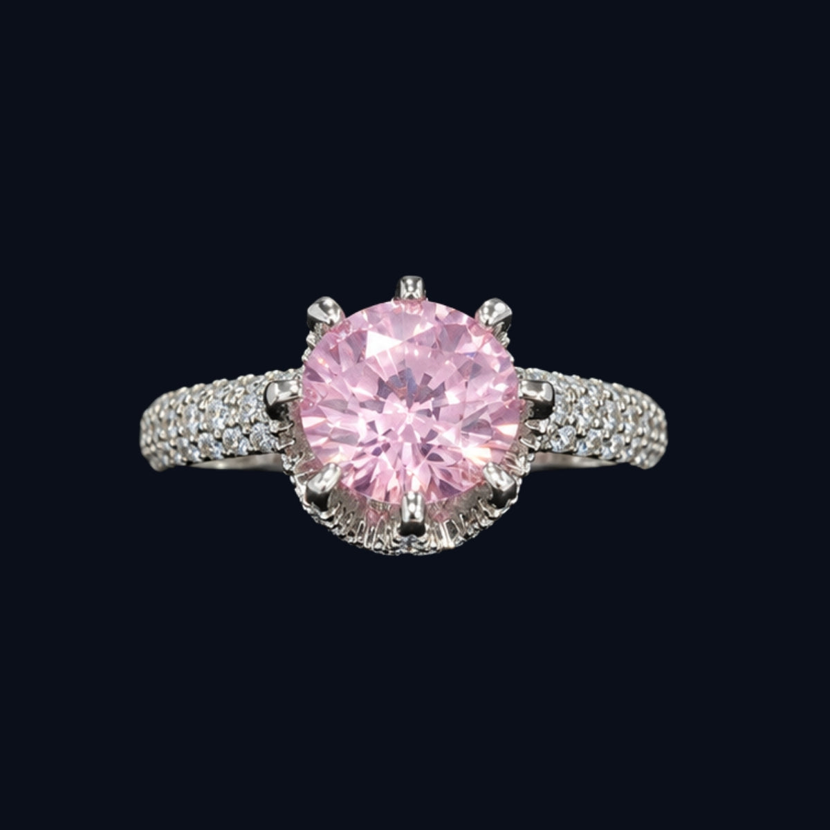 A silver ring with a large pink CZ stone and small clear stones on the band.