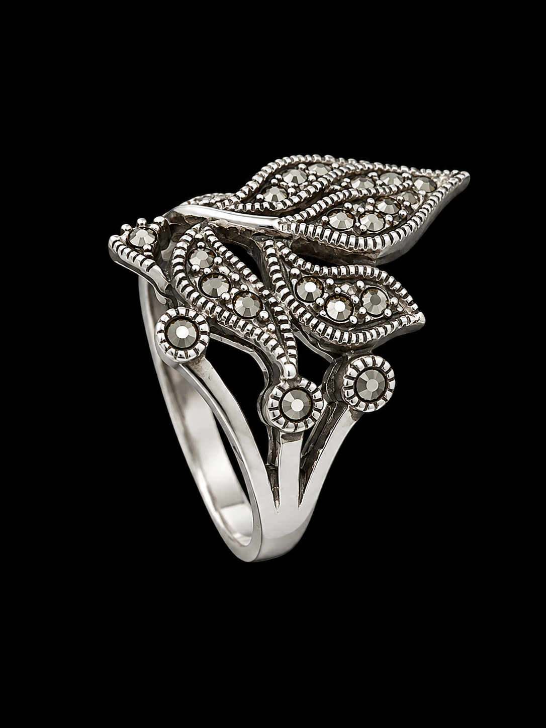 A silver ring with intricate details and CZ stones