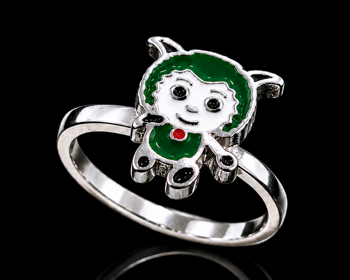 A silver-tone ring with a green girl design and red enamel accent.