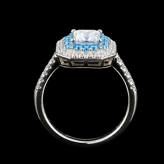 A square-cut CZ stone ring with a blue and white CZ stone halo and silver-tone metal.