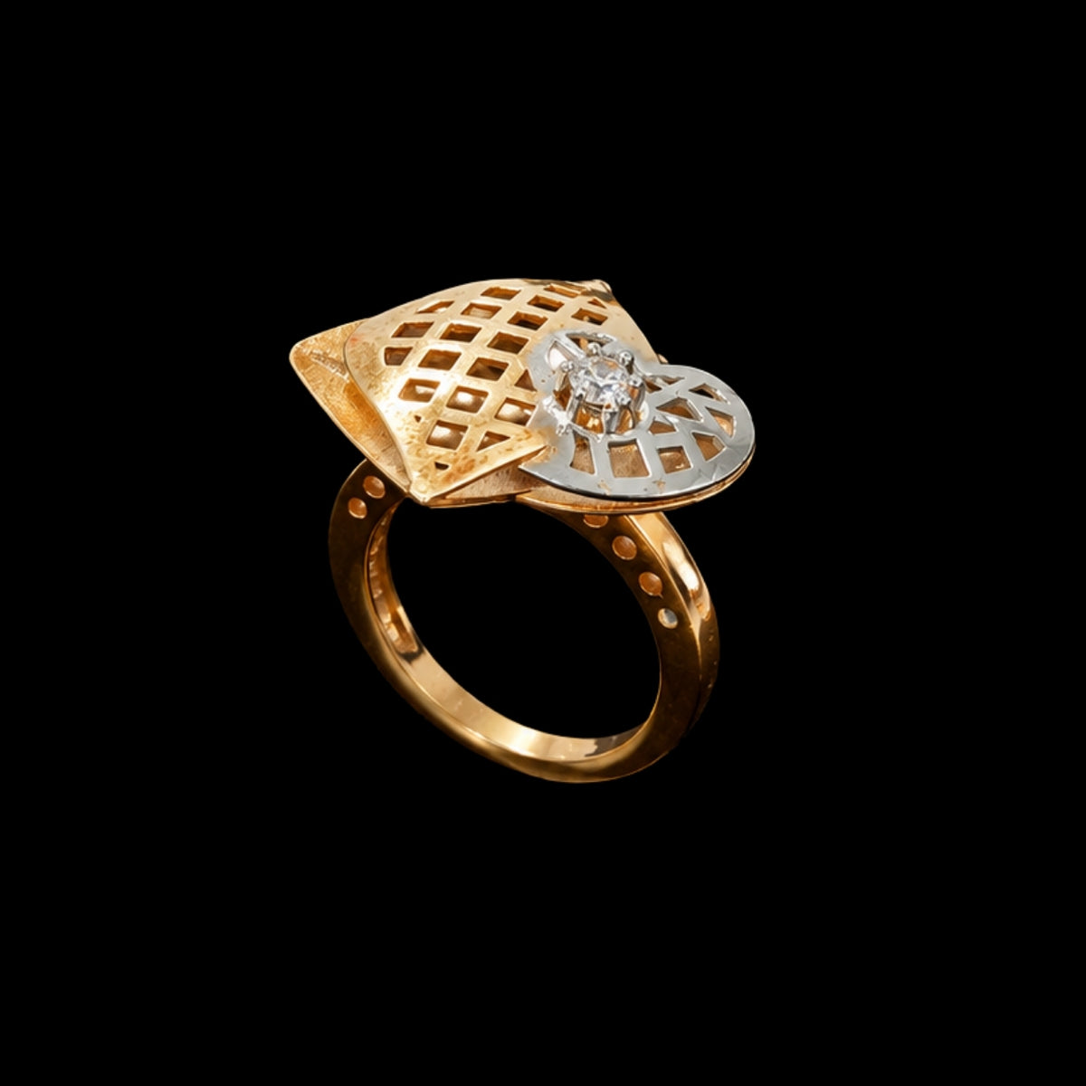 A gold-tone ring with a CZ stone and a geometric design.