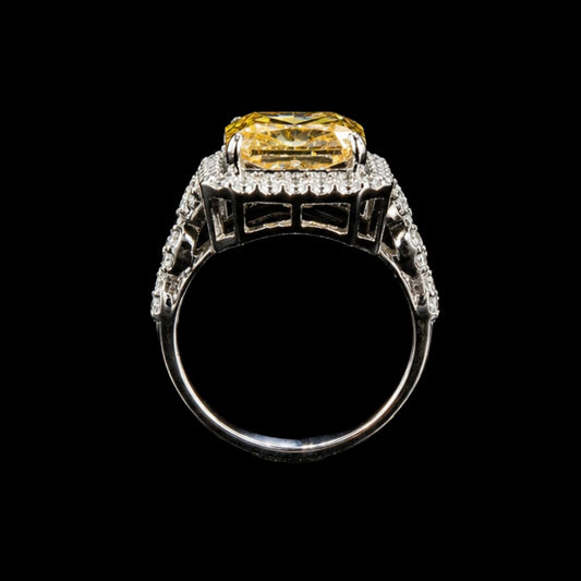 A silver ring with a large yellow CZ stone in the center, surrounded by a halo of smaller stones.