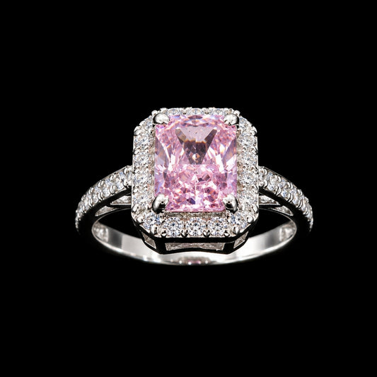 A silver ring with a large pink CZ stone and a halo of smaller stones.