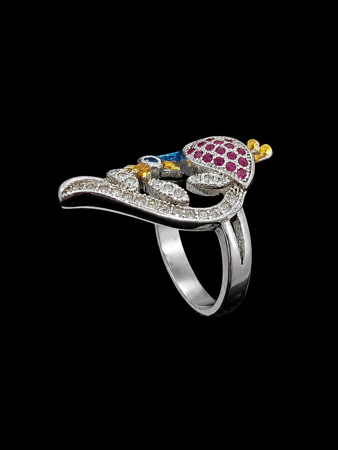 A silver ring with a pistol design, featuring intricate enamel work and CZ stones.