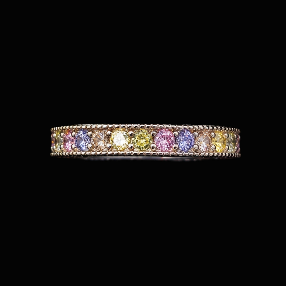 A delicate ring featuring a row of pastel-colored CZ stones.