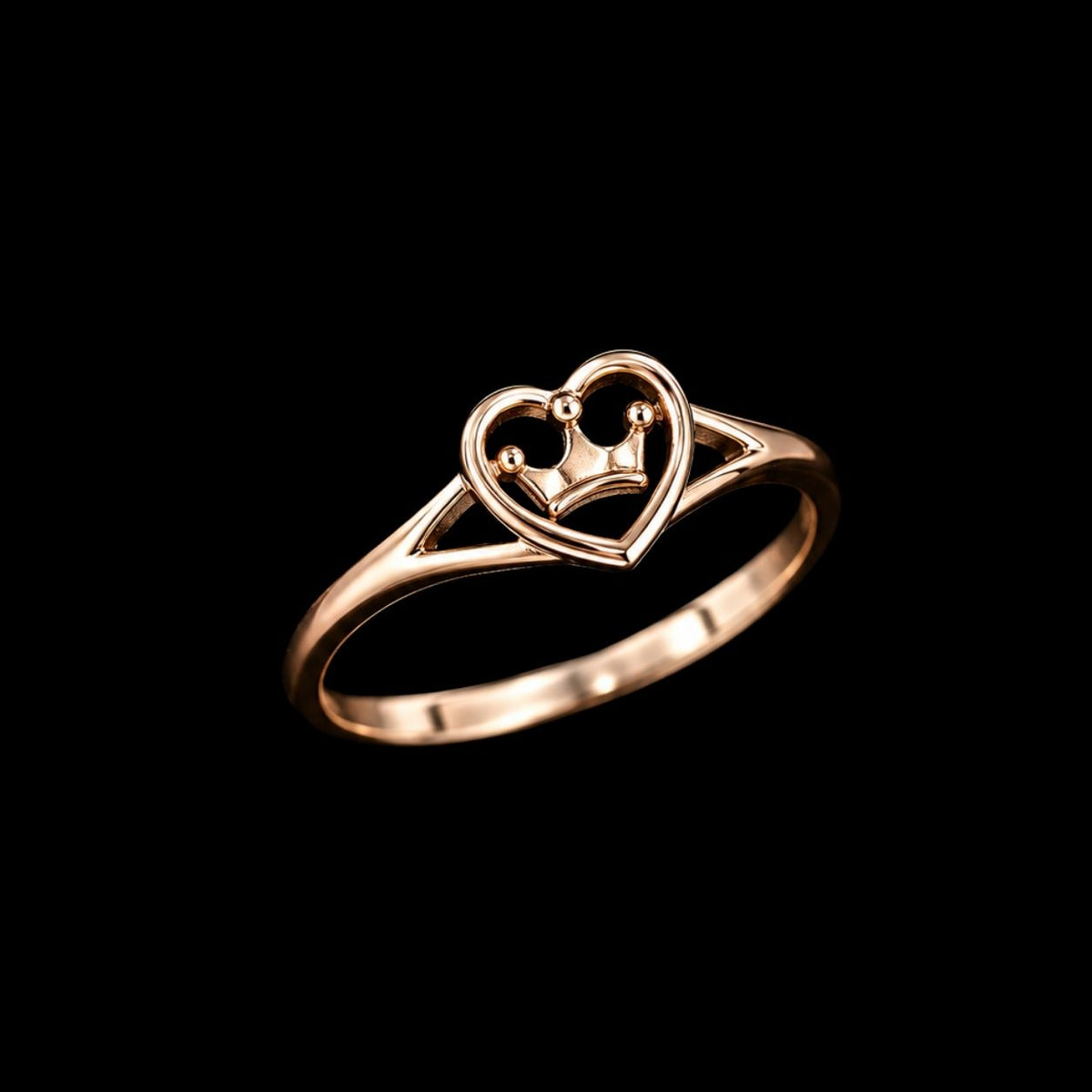 A rose gold ring with a heart-shaped design featuring a crown motif.