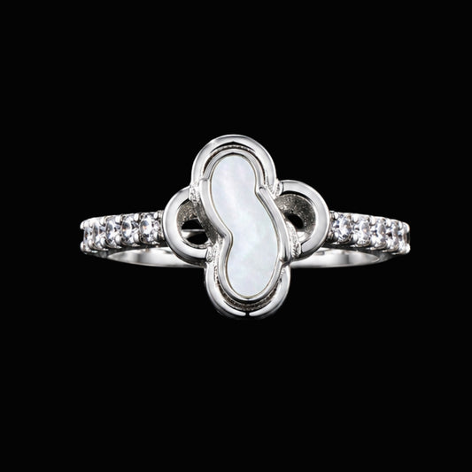 A silver ring with clear CZ stones on a black background.