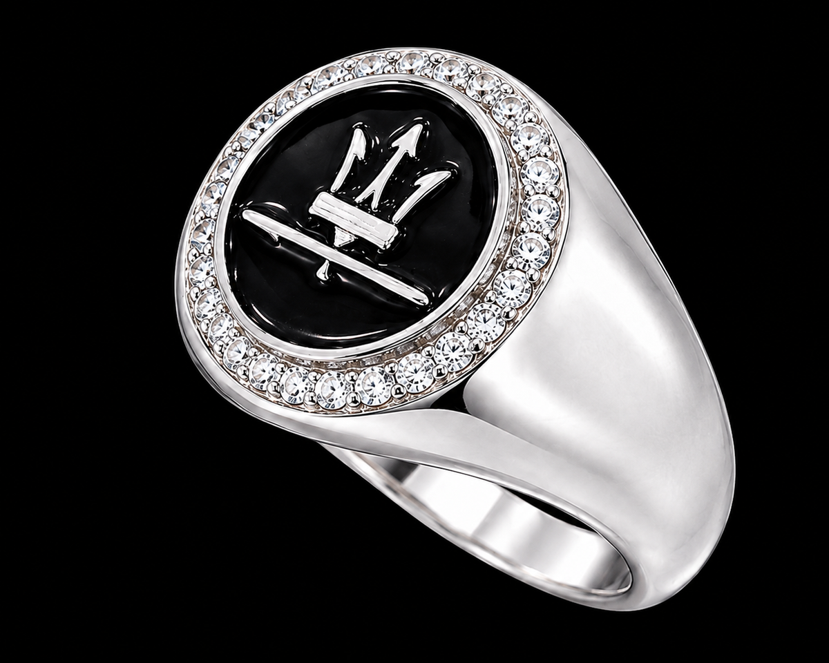 A silver ring with a black enamel Maserati logo and clear CZ stones