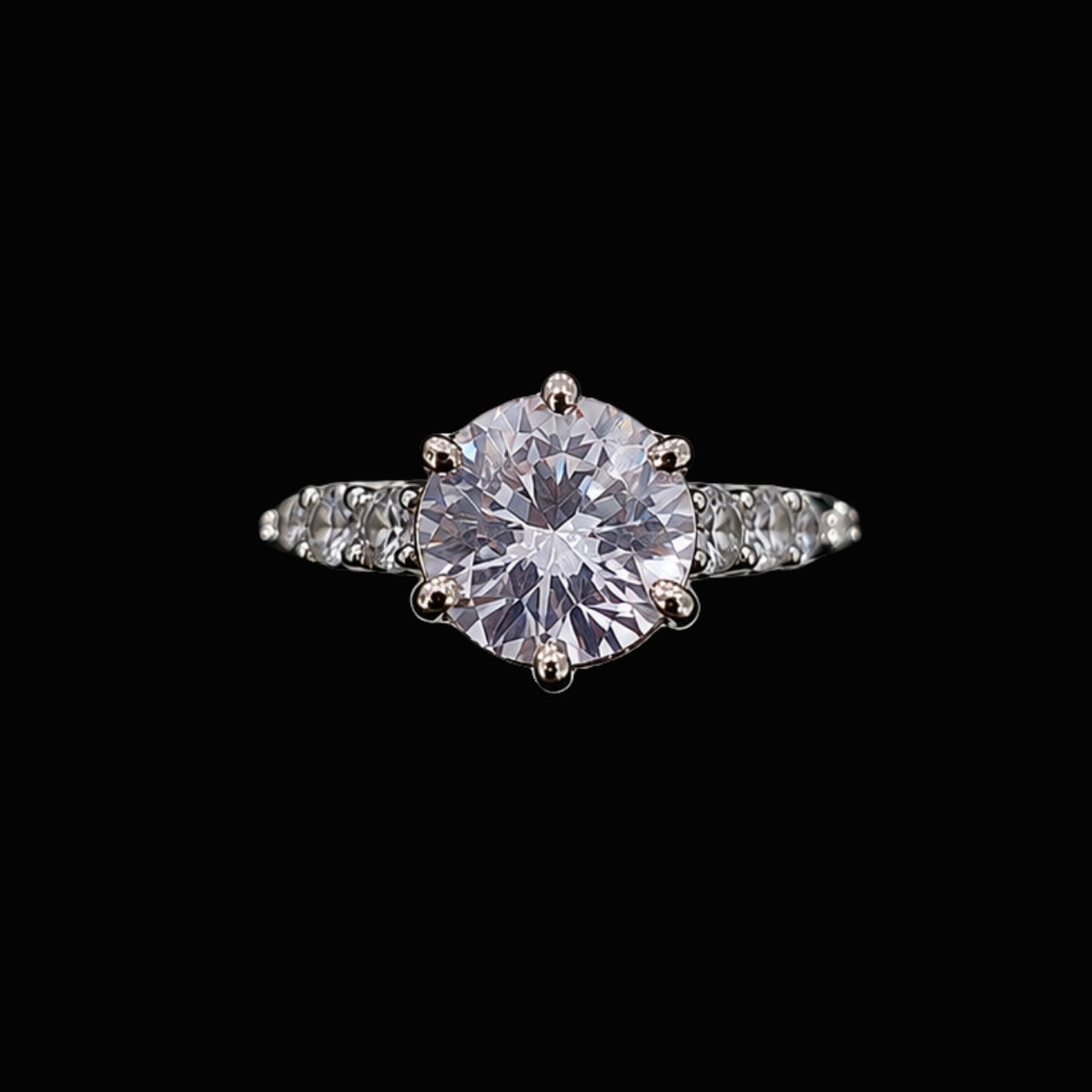 A silver ring with a round cut stone set in a classic setting.