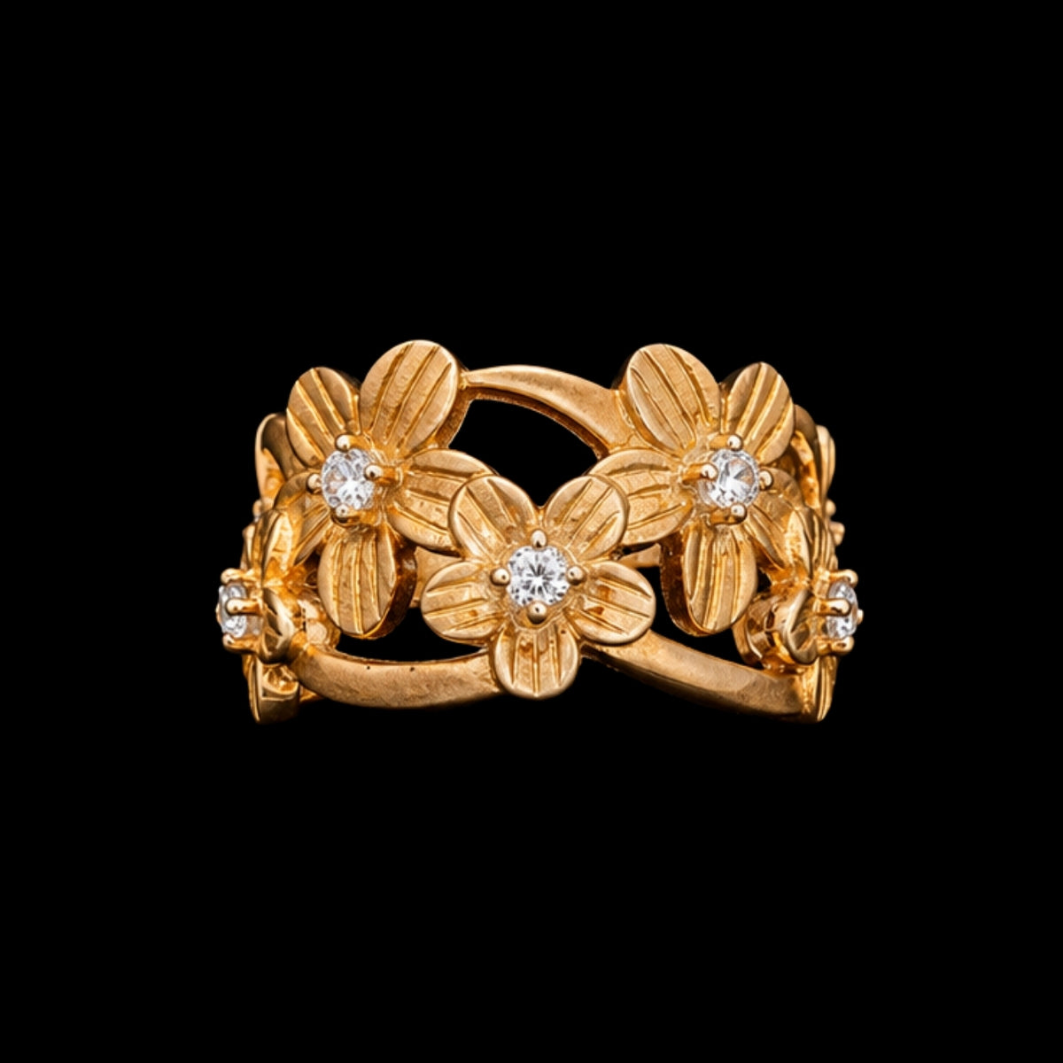 A gold tone ring with a floral motif and CZ stones.