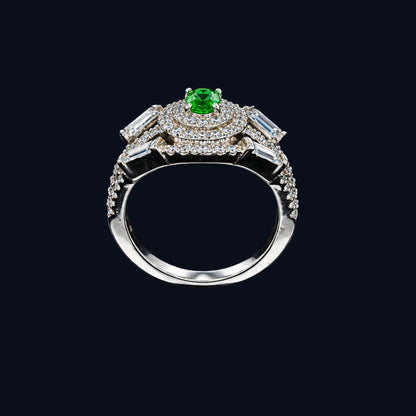 A silver ring with an emerald stone and CZ stones on a black background
