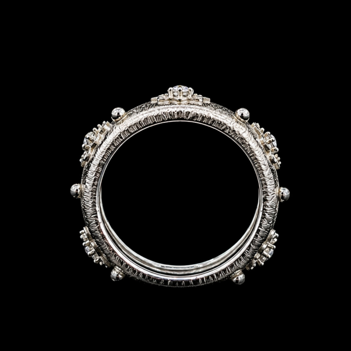 A silver ring with a crown motif and CZ stones.