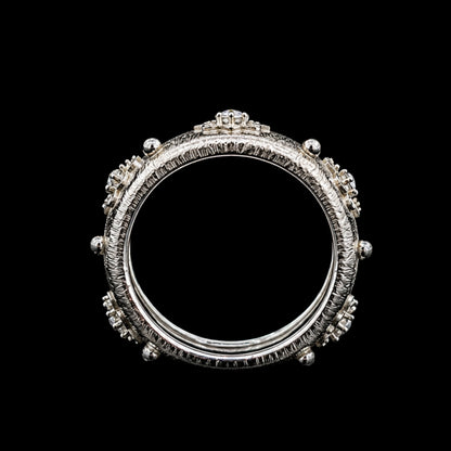 A silver ring with a crown motif and CZ stones.