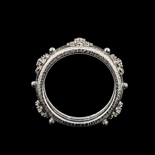 A silver ring with a crown motif and CZ stones.