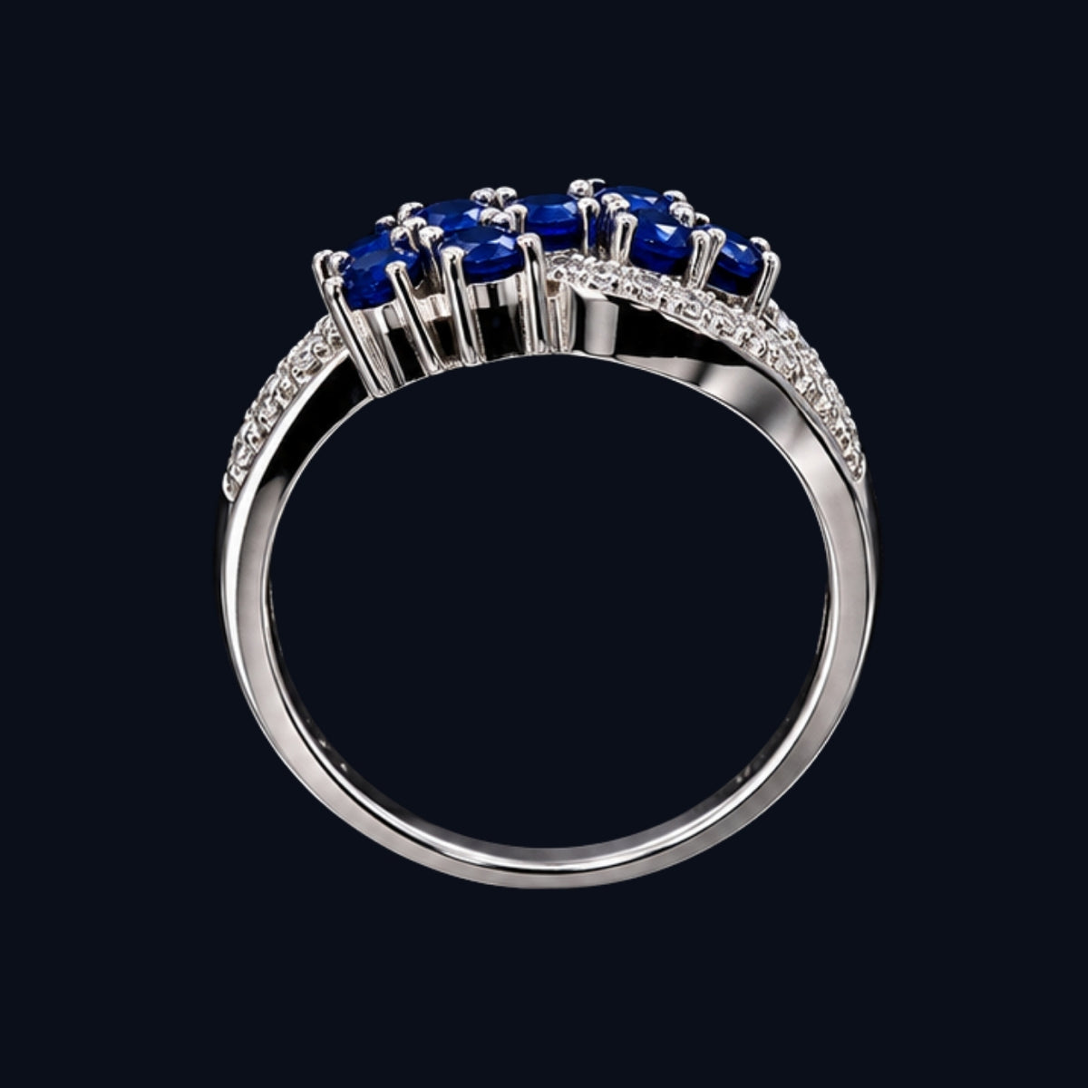 A silver ring with three blue gemstones, set in a classic design.