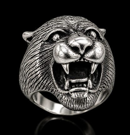 A close-up shot of a tiger ring with a detailed tiger head design and CZ stones.