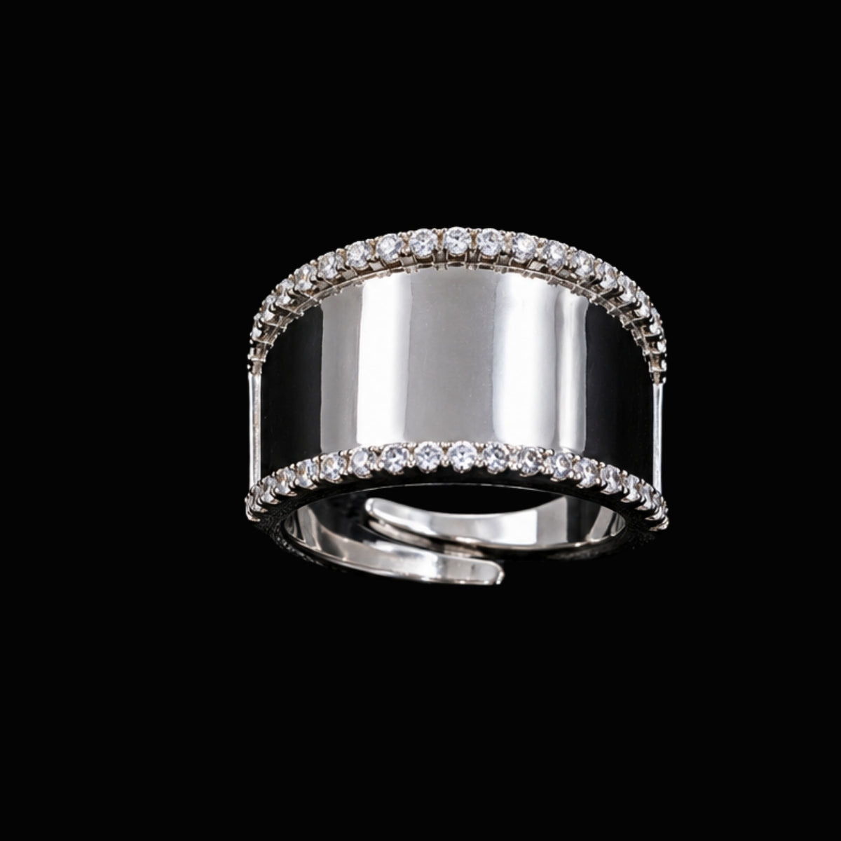 A silver ring with a wide band and round-cut CZ stones.