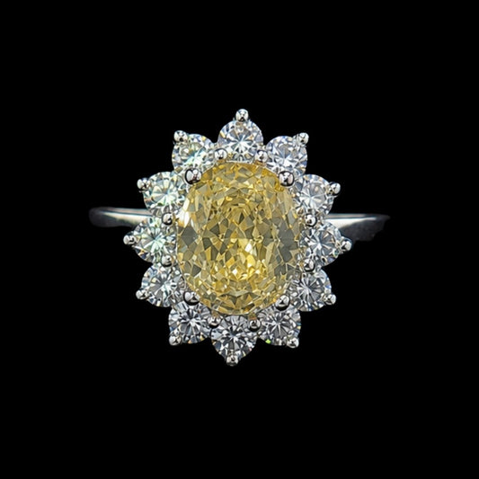 A yellow CZ ring with a floral design and clear CZ accents on a silver band.